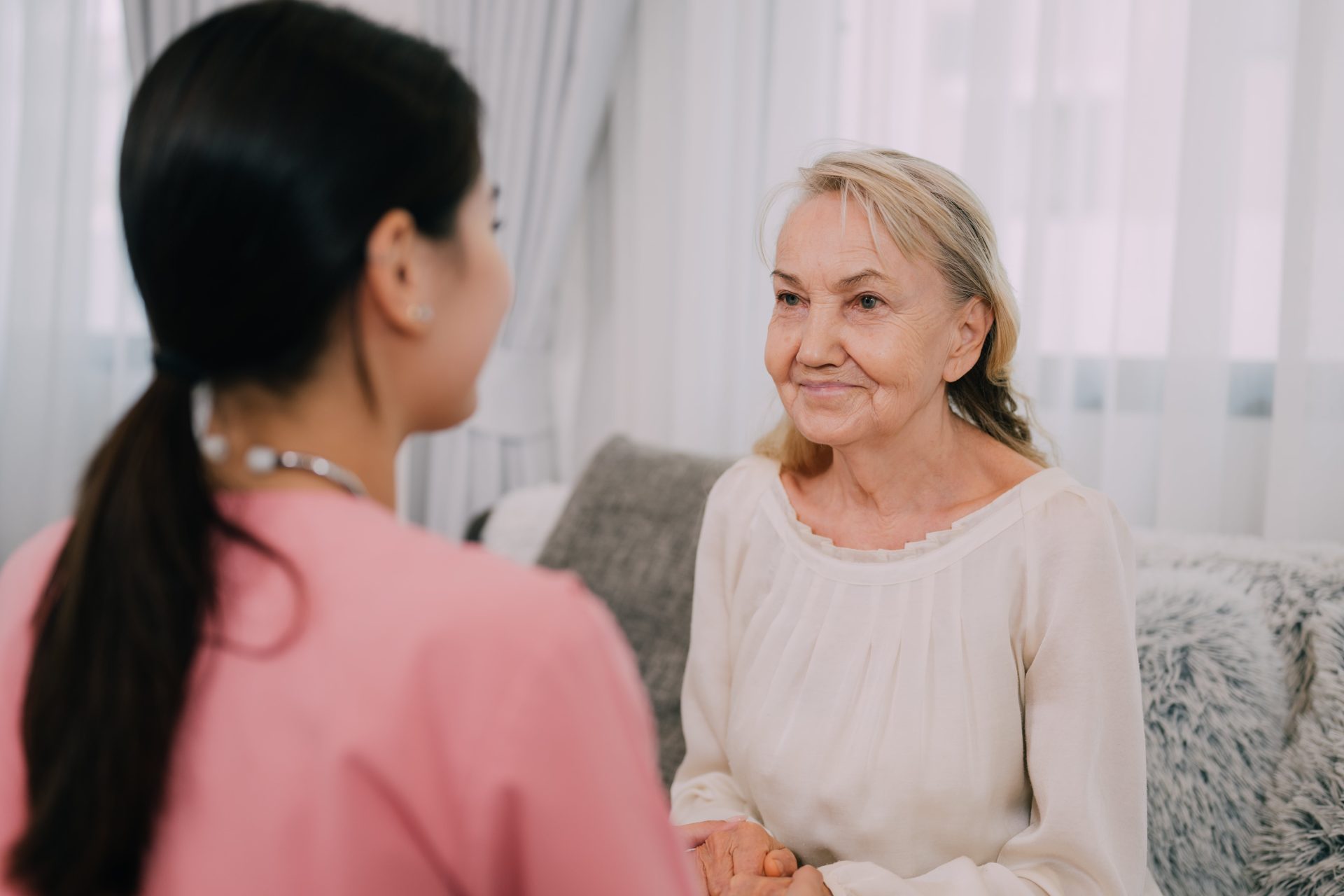 happy-senior-woman-talking-with-female-caregiver-2024-10-10-23-52-29-utc-min
